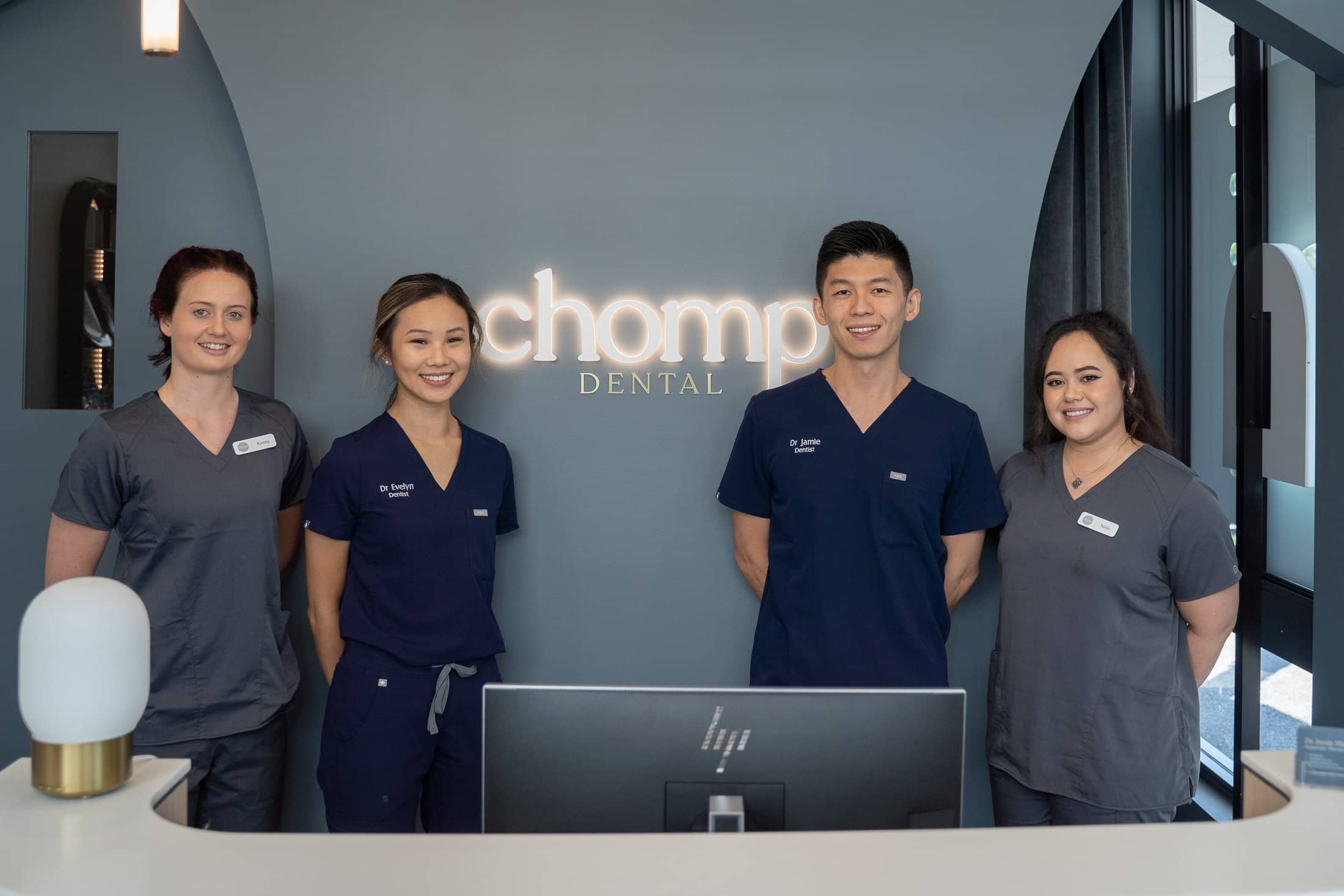 A group picture of the dentists from Chomp Dental at the front desk