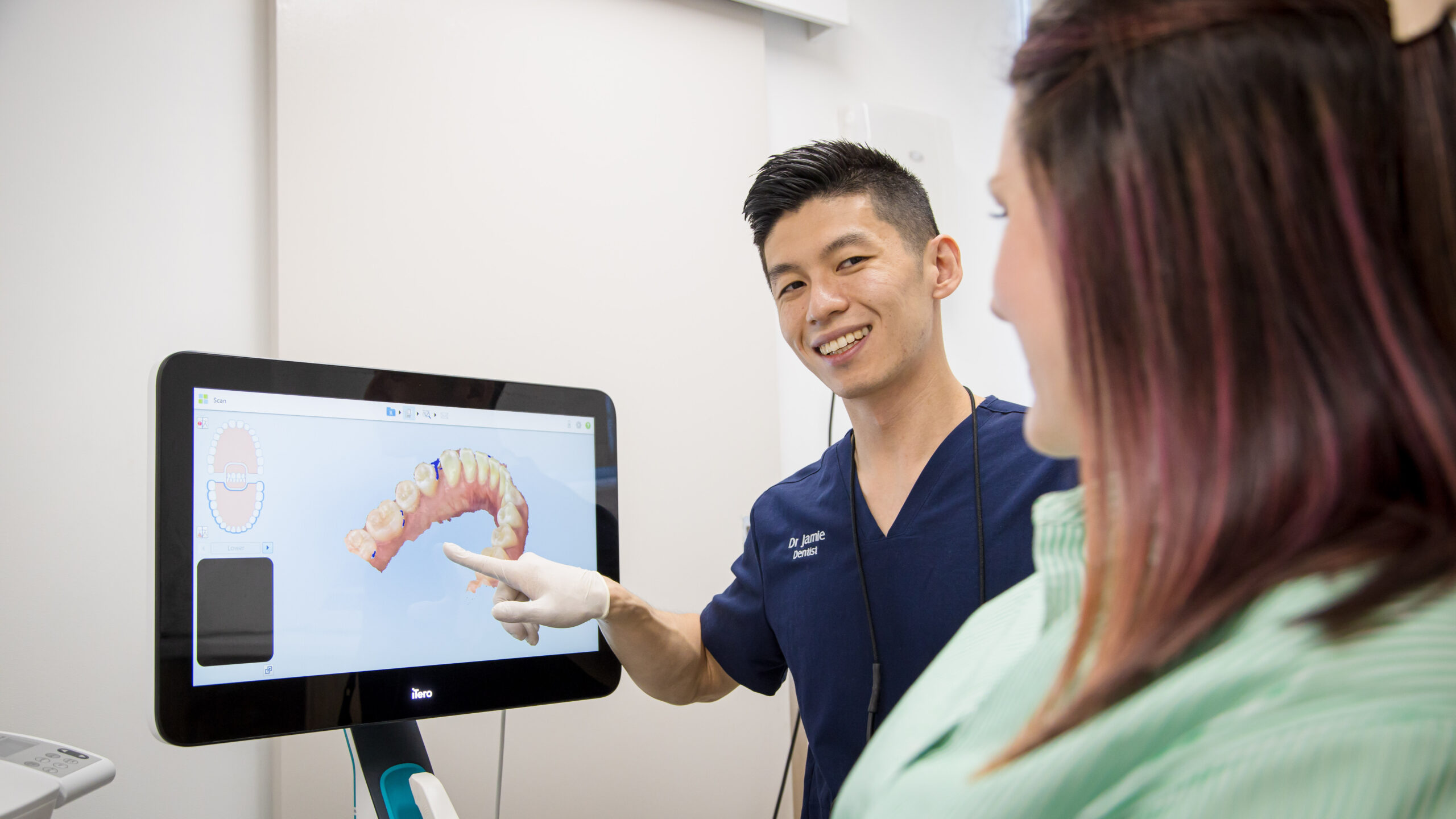 The dentist at Chomp Dental explains to the patient how long dental crowns last.