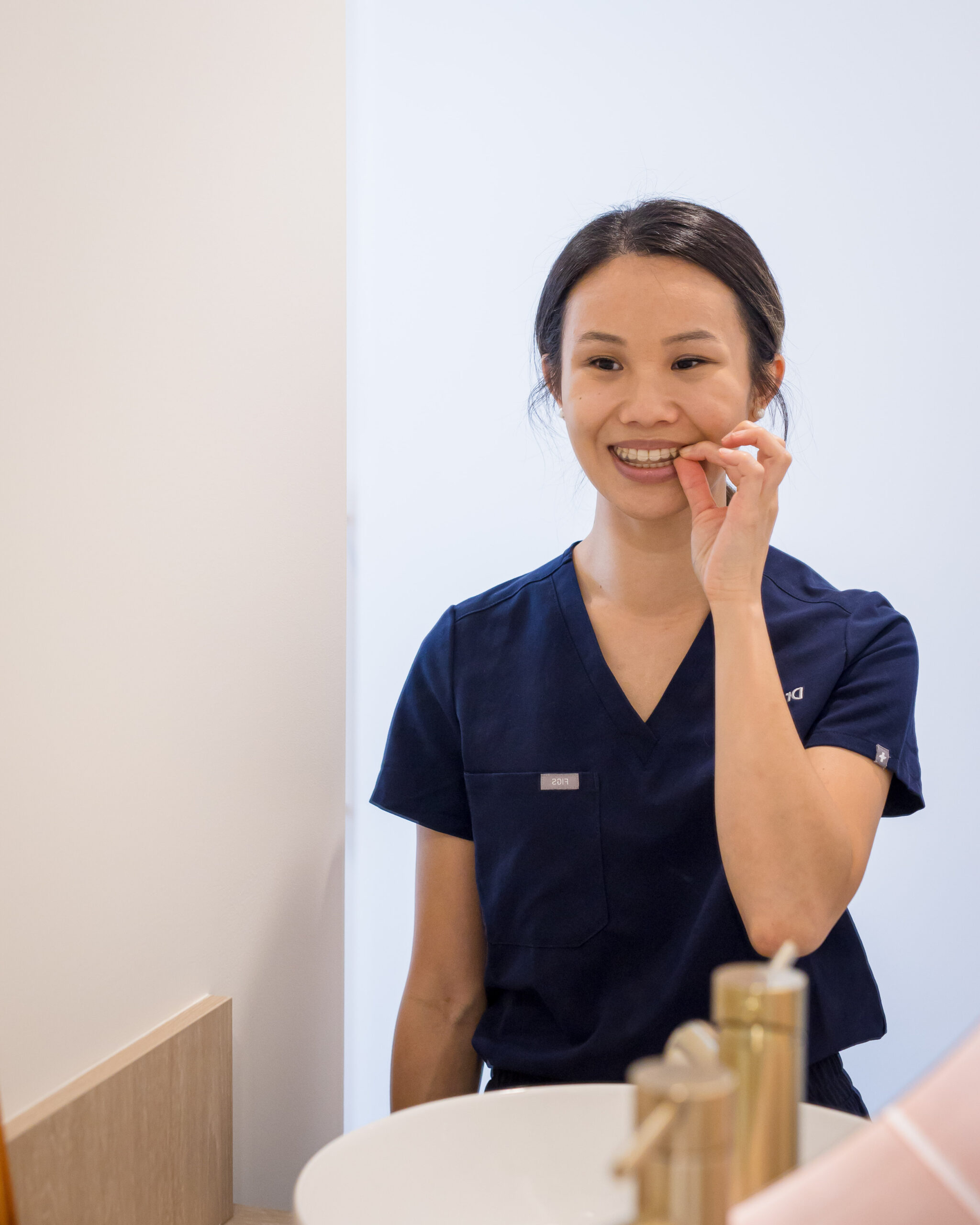 An Invisalign & Clear Aligner installation demonstration is being given by a dentist from Chomp Dental.