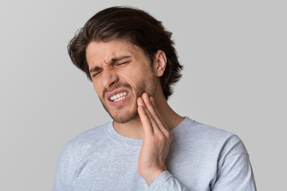A man in pain needs emergency dentist at Chomp Dental